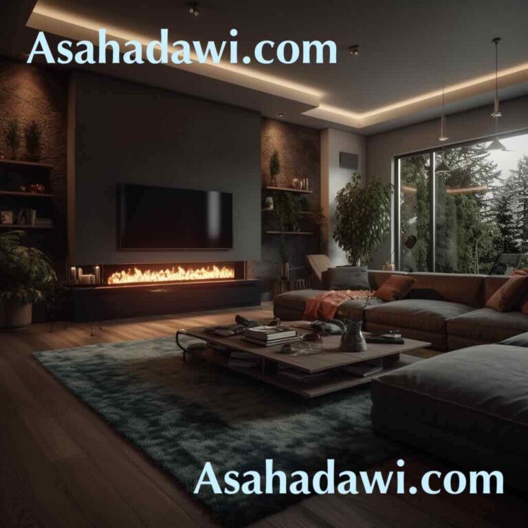 Asahadawi.com Modern living room with a corner entertainment unit. The room has a grey sofa and a wooden coffee table, and a patterned rug. A flat-screen TV is mounted on the wall above a wooden storage unit with a black countertop. The storage unit has several shelves and drawers, and there is a built-in fireplace with a glass panel. The walls are painted in light grey and decorated with framed artworks. The room also has large windows that provide natural light and offer views of a forest.